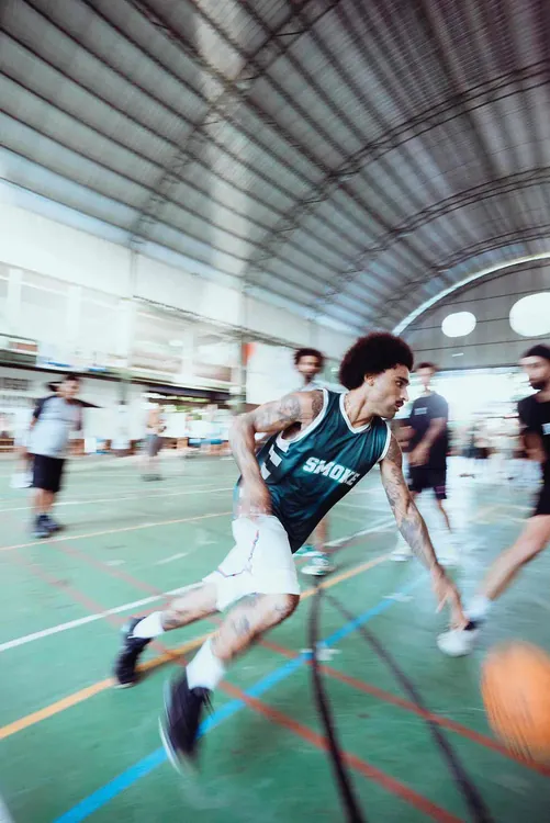A player driving to the basket in motion during a 3x3 game