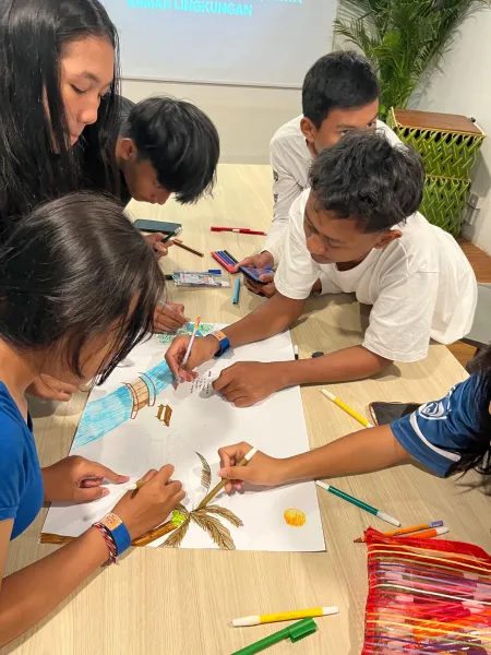 Students working together on an art and environment activity with markers.